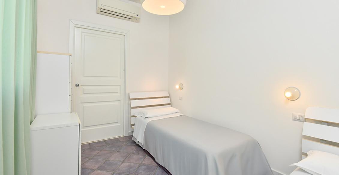 Camera luminosa con letto accogliente, vista giardino, atmosfera serena e rilassante.